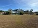 Large backyard with a white house and solar panels at 204 Charles St, Saint George, SC 29477