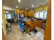 Large kitchen with oak cabinets, island, and tile floor; requires cleaning at 204 Charles St, Saint George, SC 29477