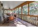 Large screened porch with wooden floors, ceiling fan, and wooded views at 362 Pelican Flight Dr, Dewees Island, SC 29451