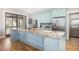 Large kitchen island with granite countertop and light blue cabinetry at 362 Pelican Flight Dr, Dewees Island, SC 29451