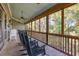 Screened porch with rocking chairs and a view of the lush greenery at 362 Pelican Flight Dr, Dewees Island, SC 29451