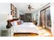 Bright bedroom with queen bed, access to balcony, and hardwood floors at 362 Pelican Flight Dr, Dewees Island, SC 29451