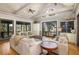 Spacious living room with vaulted ceilings, hardwood floors, and access to a deck at 362 Pelican Flight Dr, Dewees Island, SC 29451
