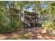 Elevated home with screened porches and decks nestled in a wooded area at 362 Pelican Flight Dr, Dewees Island, SC 29451