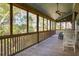Spacious screened porch overlooking a wooded area with seating for relaxing at 362 Pelican Flight Dr, Dewees Island, SC 29451