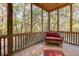 Relaxing screened porch overlooking lush trees and landscape at 362 Pelican Flight Dr, Dewees Island, SC 29451