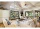 Living room with vaulted ceilings, hardwood floors, and access to a deck at 362 Pelican Flight Dr, Dewees Island, SC 29451