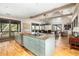 Open concept kitchen with island, granite counters, and hardwood floors at 362 Pelican Flight Dr, Dewees Island, SC 29451