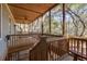 Upstairs screened porch with wooded views at 362 Pelican Flight Dr, Dewees Island, SC 29451