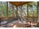 Spacious screened porch with wooden floors and wooded views at 362 Pelican Flight Dr, Dewees Island, SC 29451