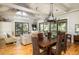 Open concept dining room with hardwood floors and a chandelier adjacent to the living room at 362 Pelican Flight Dr, Dewees Island, SC 29451