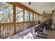 Relaxing screened porch with wooden floors and rocking chairs at 362 Pelican Flight Dr, Dewees Island, SC 29451
