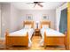 Bright bedroom with two twin beds and hardwood floors at 362 Pelican Flight Dr, Dewees Island, SC 29451