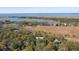 Aerial view showcasing waterfront property and marsh views at 362 Pelican Flight Dr, Dewees Island, SC 29451