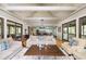 Open concept living room with hardwood floors and view into kitchen and dining area at 362 Pelican Flight Dr, Dewees Island, SC 29451