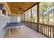 Relaxing screened porch with ping pong table and wooded views at 362 Pelican Flight Dr, Dewees Island, SC 29451