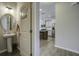 Half bathroom with pedestal sink and view into kitchen at 415 Snowy Plover Ln, Summerville, SC 29486