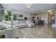Open living room with hardwood floors, large windows, and view into the kitchen at 415 Snowy Plover Ln, Summerville, SC 29486