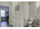 Powder room with pedestal sink and toilet, view into laundry room at 415 Snowy Plover Ln, Summerville, SC 29486