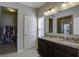 Main bathroom with double vanity, granite countertop, and walk-in shower at 415 Snowy Plover Ln, Summerville, SC 29486