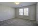Well-lit bedroom featuring large window and carpet at 415 Snowy Plover Ln, Summerville, SC 29486