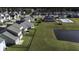 Aerial view of houses, a pond, and a community pool at 415 Snowy Plover Ln, Summerville, SC 29486