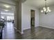 Bright dining room with hardwood floors and chandelier, view into living room and kitchen at 415 Snowy Plover Ln, Summerville, SC 29486