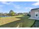 Large backyard with pond and neighboring houses in view at 510 Eastern Isle Ave, Summerville, SC 29486