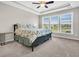 Main bedroom with a floral comforter and large windows offering a garden view at 510 Eastern Isle Ave, Summerville, SC 29486