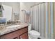 Updated bathroom features granite countertop, updated vanity, and a striped shower curtain at 510 Eastern Isle Ave, Summerville, SC 29486