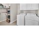 Laundry room with washer, dryer, and ample storage shelving at 510 Eastern Isle Ave, Summerville, SC 29486