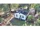 Aerial view of a white house with a large yard and surrounding trees at 1860/1858 Taberwood Cir, Charleston, SC 29407