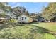 Yellow house with side yard and mature trees at 1860/1858 Taberwood Cir, Charleston, SC 29407