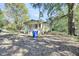 Yellow house with front porch, situated on a lot with mature trees at 1860/1858 Taberwood Cir, Charleston, SC 29407