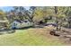 Aerial view of a yellow house with a large yard and detached garage at 1860/1858 Taberwood Cir, Charleston, SC 29407
