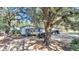 White house with large trees, a dog house, and a black SUV in the driveway at 1860/1858 Taberwood Cir, Charleston, SC 29407
