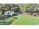 Aerial view of a yellow house with a large yard and detached garage at 1860/1858 Taberwood Cir, Charleston, SC 29407