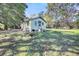 Yellow house with side yard and mature trees at 1860/1858 Taberwood Cir, Charleston, SC 29407