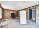 A fixer-upper kitchen with wood paneling, white refrigerator, and worn flooring at 1860/1858 Taberwood Cir, Charleston, SC 29407