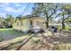 Yellow house with a porch and large trees in the front yard at 1860/1858 Taberwood Cir, Charleston, SC 29407