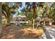 House with detached garage, surrounded by trees and lush landscaping at 2588 High Hammock Rd, Johns Island, SC 29455