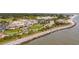Aerial view of coastal community with clubhouse, pool, and oceanfront access at 2588 High Hammock Rd, Johns Island, SC 29455