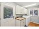 Bright laundry room with washer, dryer, and extra storage at 2588 High Hammock Rd, Johns Island, SC 29455
