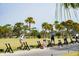 Golf driving range with palm trees and several golfers at 2588 High Hammock Rd, Johns Island, SC 29455