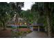 Night view of house and detached garage with warm lighting at 2588 High Hammock Rd, Johns Island, SC 29455