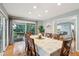 Bright dining room with large table, hardwood floors, and sliding glass doors leading to a deck at 2588 High Hammock Rd, Johns Island, SC 29455