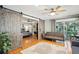 Main bedroom with barn doors leading to the en-suite bathroom and hardwood floors at 2588 High Hammock Rd, Johns Island, SC 29455