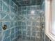 Large walk-in shower with blue tile and multiple shower heads at 2588 High Hammock Rd, Johns Island, SC 29455