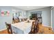 Spacious dining room features a large table, hardwood floors and views into adjacent rooms at 2588 High Hammock Rd, Johns Island, SC 29455