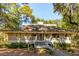 Light beige home with a gabled roof, double doors, and a deck at 2588 High Hammock Rd, Johns Island, SC 29455